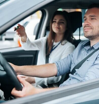 young-man-driving-car-with-his-instructor_ Female Driving Instructors in Woolwhich