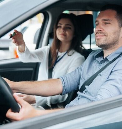 young-man-driving-car-with-his-instructor_ Female Driving Instructors in Woolwhich